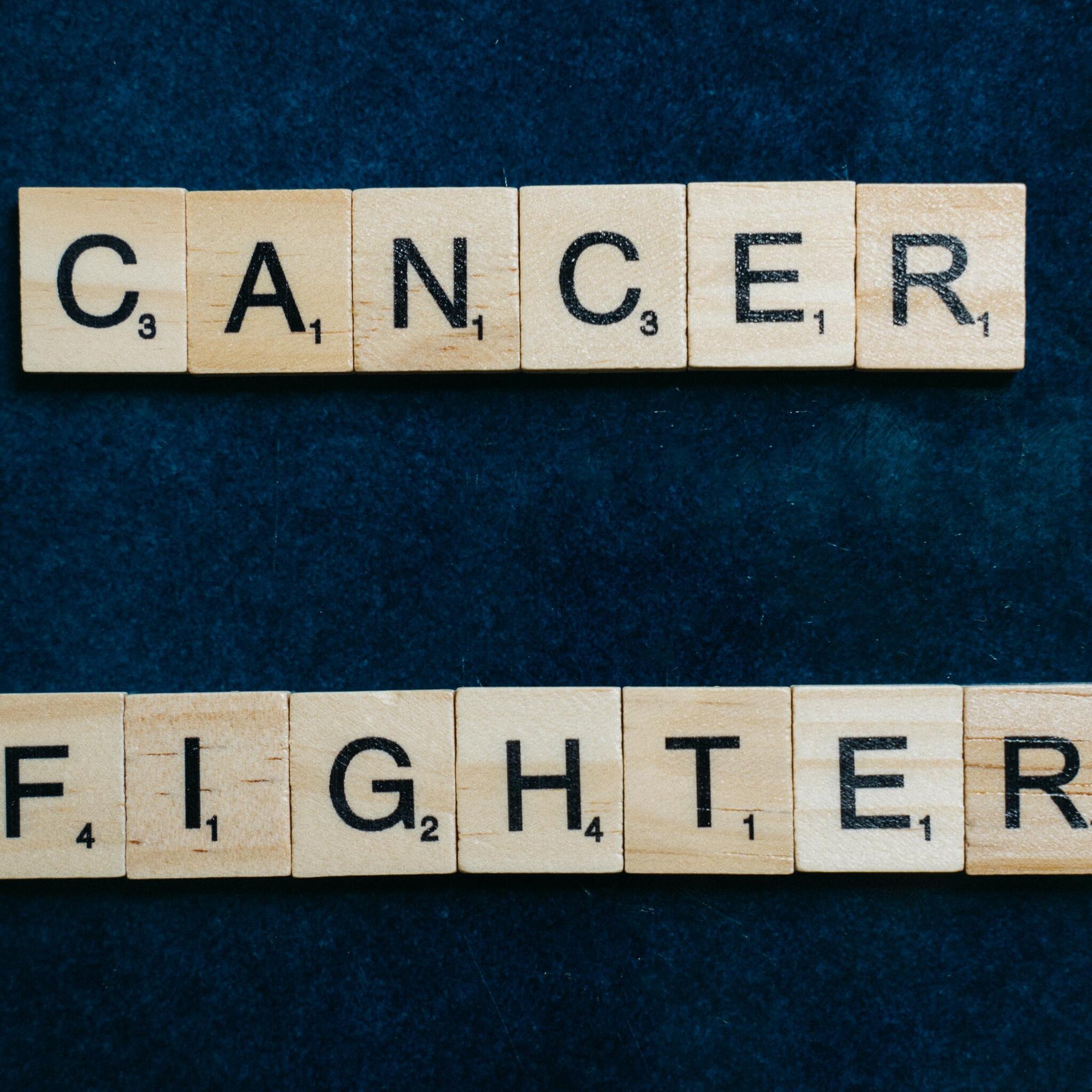 Scrabble tiles that spell "Cancer Fighter"