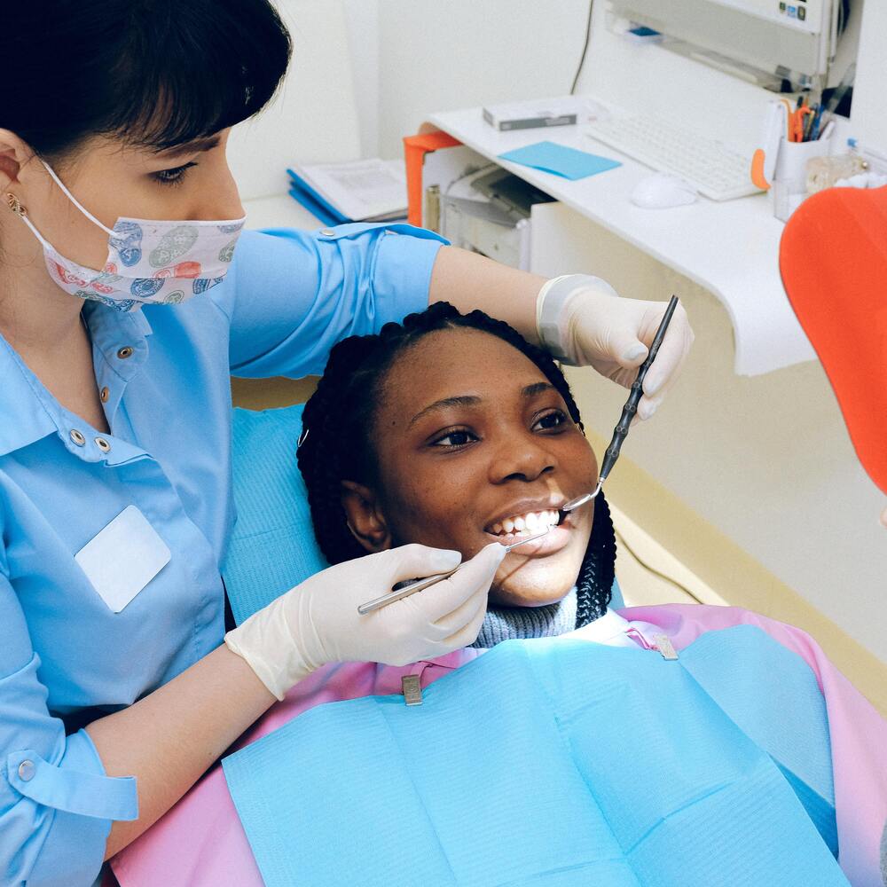 Patient getting a dental cleaning from a dental professional
